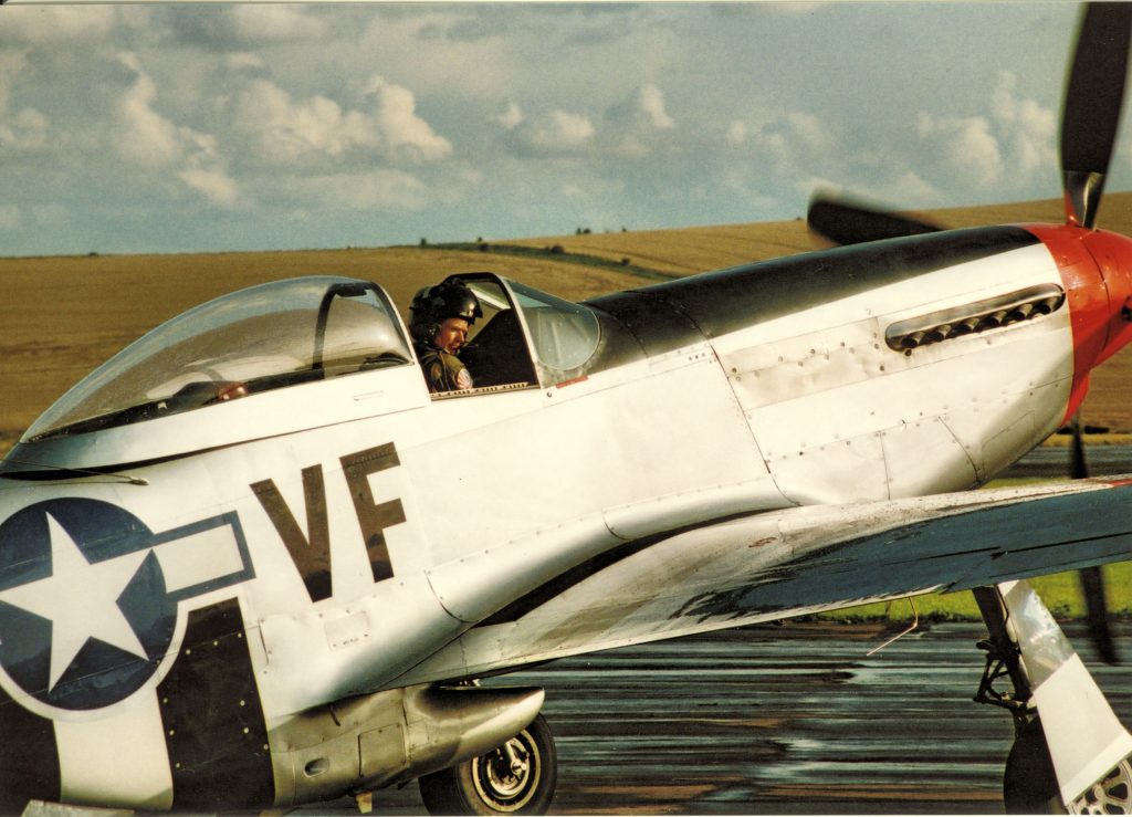 Mustang fighter on tarmac with pilot in the cockpit